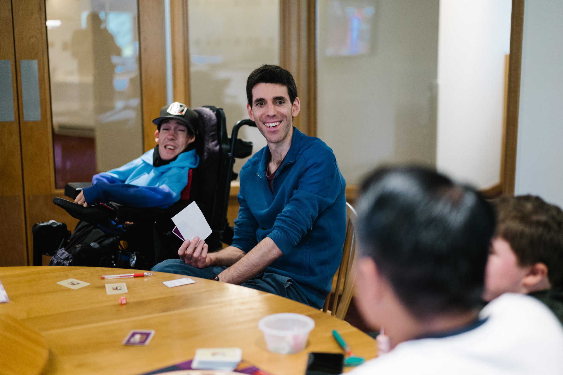 Young adults enjoying games together at a hospice day service